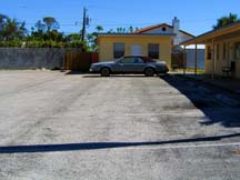 a squat and yellow boarded up building